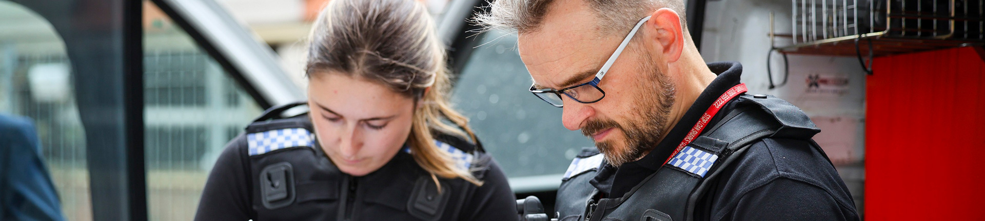 Officers processing goods found in back on van